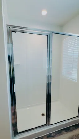a bathroom with a glass shower door