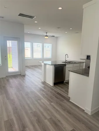 a large kitchen with stainless steel appliances granite countertop a stove and a refrigerator