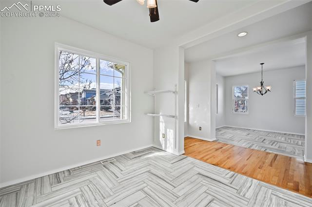 10165 Angeles Road Peyton, CO 80831 - Photo 20 of 38 Unfurnished room featuring light hardwood / wood-style floors and ceiling fan with notable chandelier