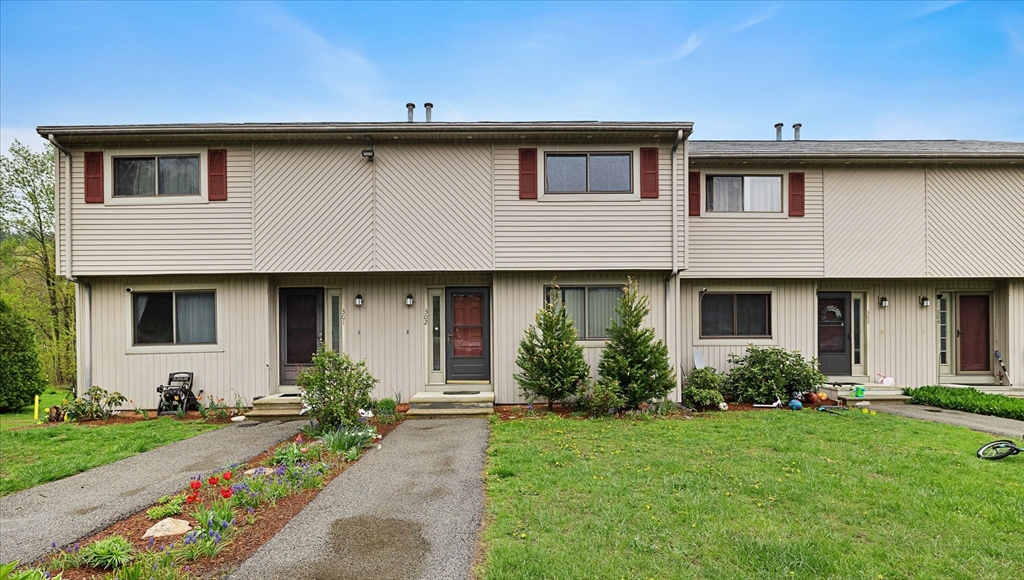 28 Southbridge Road, Unit 302 Charlton, MA 01507 - Photo 1 of 27 a front view of a house with a garden
