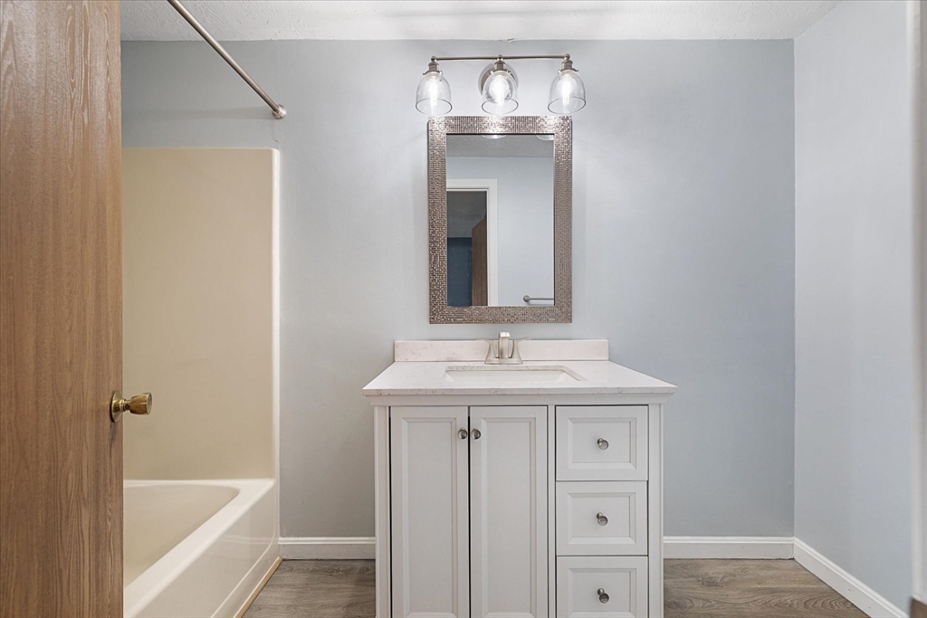 28 Southbridge Road, Unit 302 Charlton, MA 01507 - Photo 14 of 27 a bathroom with a bathtub a sink and a mirror