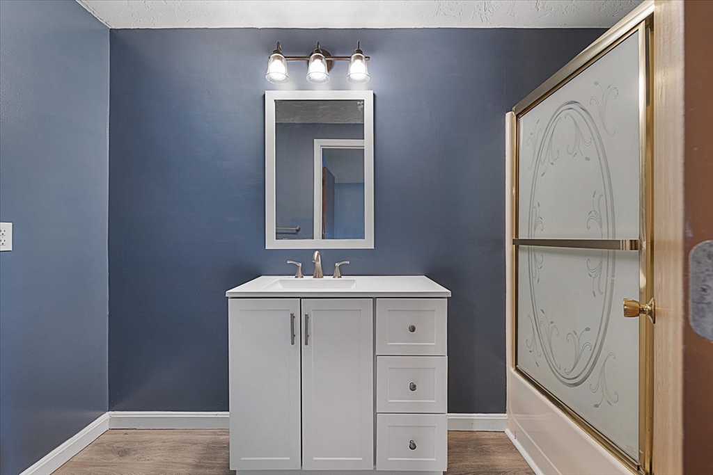 28 Southbridge Road, Unit 302 Charlton, MA 01507 - Photo 17 of 27 a bathroom with a granite countertop sink a mirror and shower