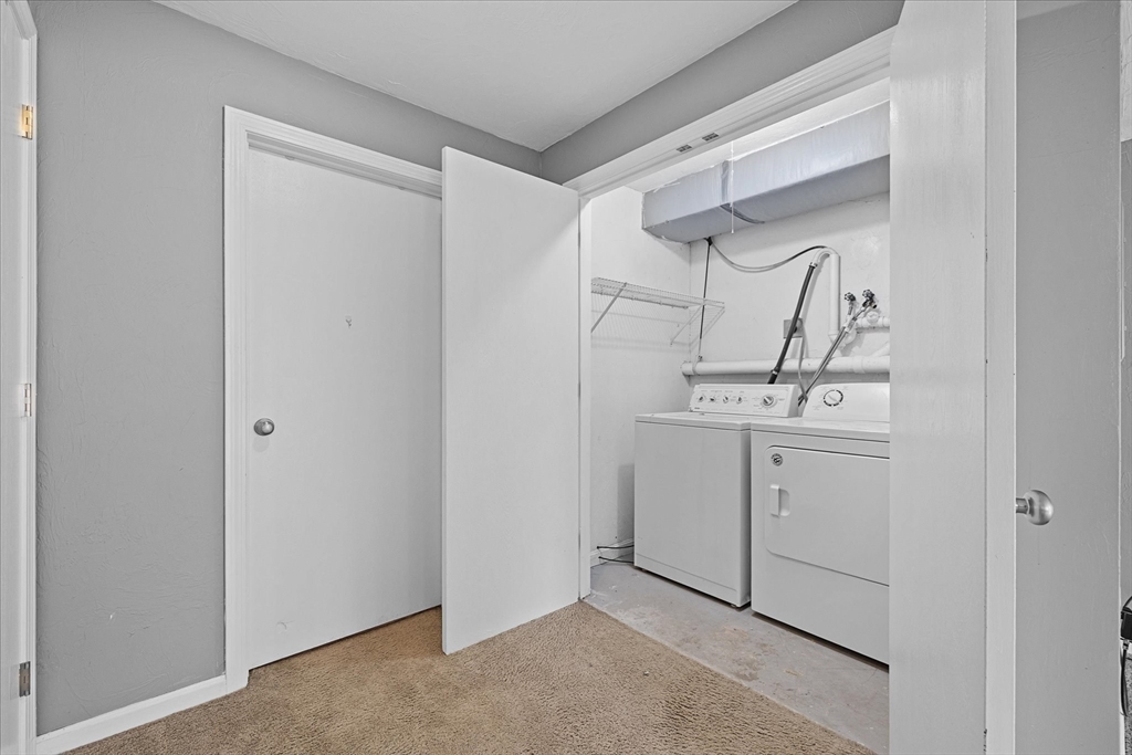 28 Southbridge Road, Unit 302 Charlton, MA 01507 - Photo 21 of 27 a utility room with cabinets washer and dryer