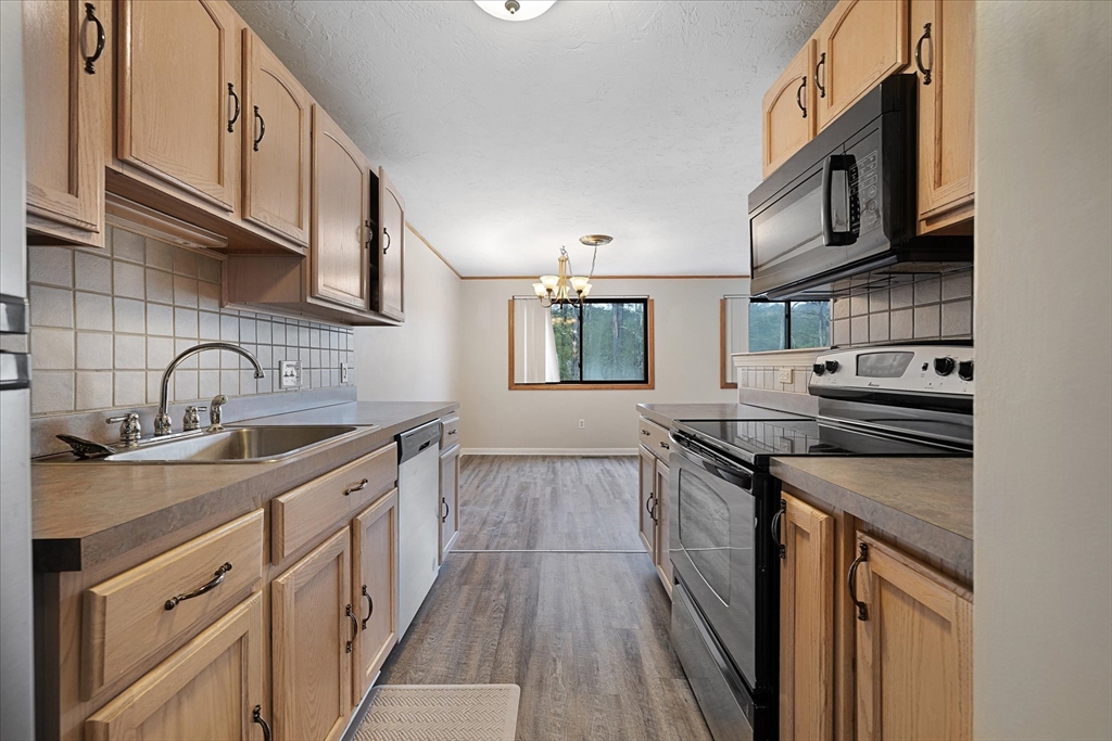 28 Southbridge Road, Unit 302 Charlton, MA 01507 - Photo 3 of 27 a kitchen with stainless steel appliances granite countertop sink stove top oven and cabinets