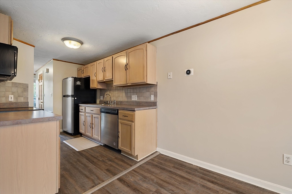 28 Southbridge Road, Unit 302 Charlton, MA 01507 - Photo 4 of 27 a kitchen with granite countertop a refrigerator stove top oven and sink