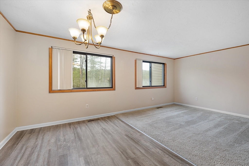 28 Southbridge Road, Unit 302 Charlton, MA 01507 - Photo 6 of 27 a view of an empty room with wooden floor and a window