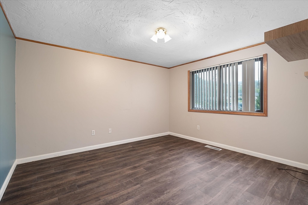 28 Southbridge Road, Unit 302 Charlton, MA 01507 - Photo 8 of 27 a view of an empty room with wooden floor and a window
