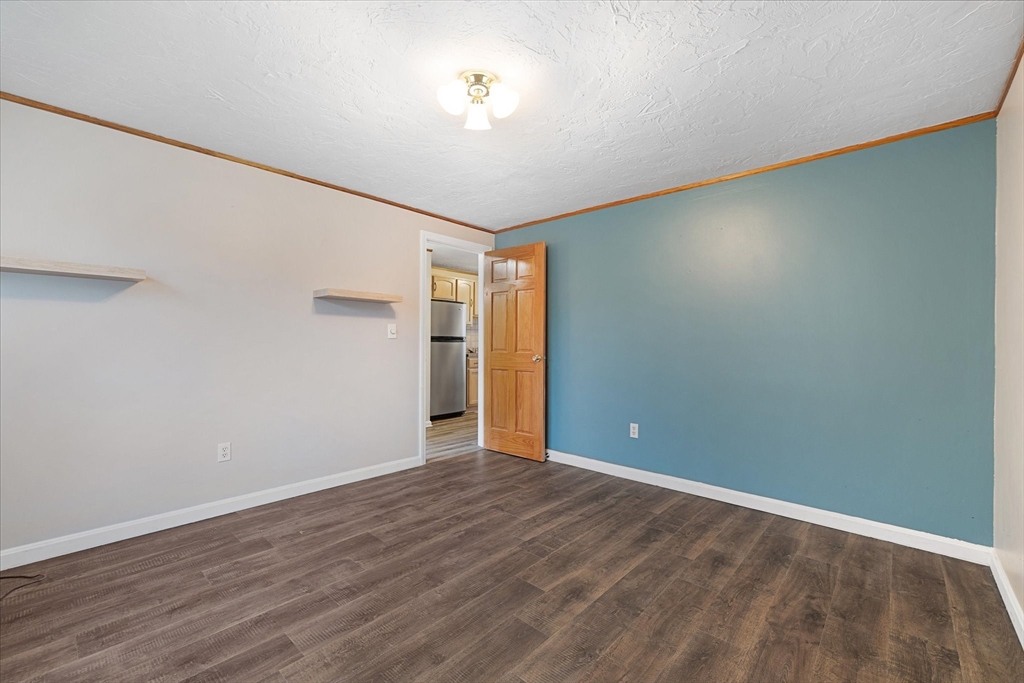 28 Southbridge Road, Unit 302 Charlton, MA 01507 - Photo 9 of 27 a view of an empty room with wooden floor