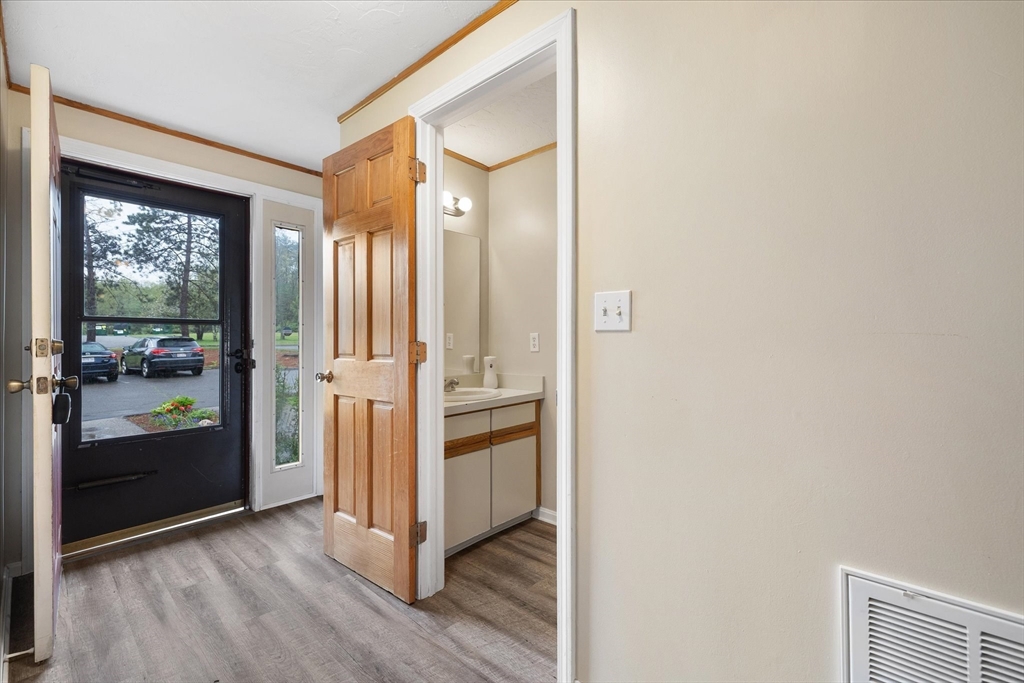 28 Southbridge Road, Unit 302 Charlton, MA 01507 - Photo 10 of 27 a view of a hallway with wooden floor and closet