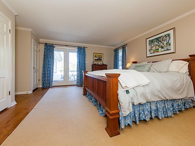 901 South County Line Road Hinsdale, IL 60521 - Photo 13 of 25 a bedroom with a large bed and a chandelier