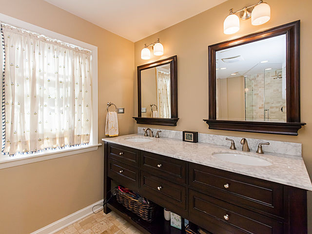 901 South County Line Road Hinsdale, IL 60521 - Photo 14 of 25 a bathroom with double vanity and a mirror