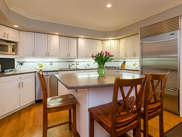 901 South County Line Road Hinsdale, IL 60521 - Photo 9 of 25 a kitchen with stainless steel appliances a table and chairs in it