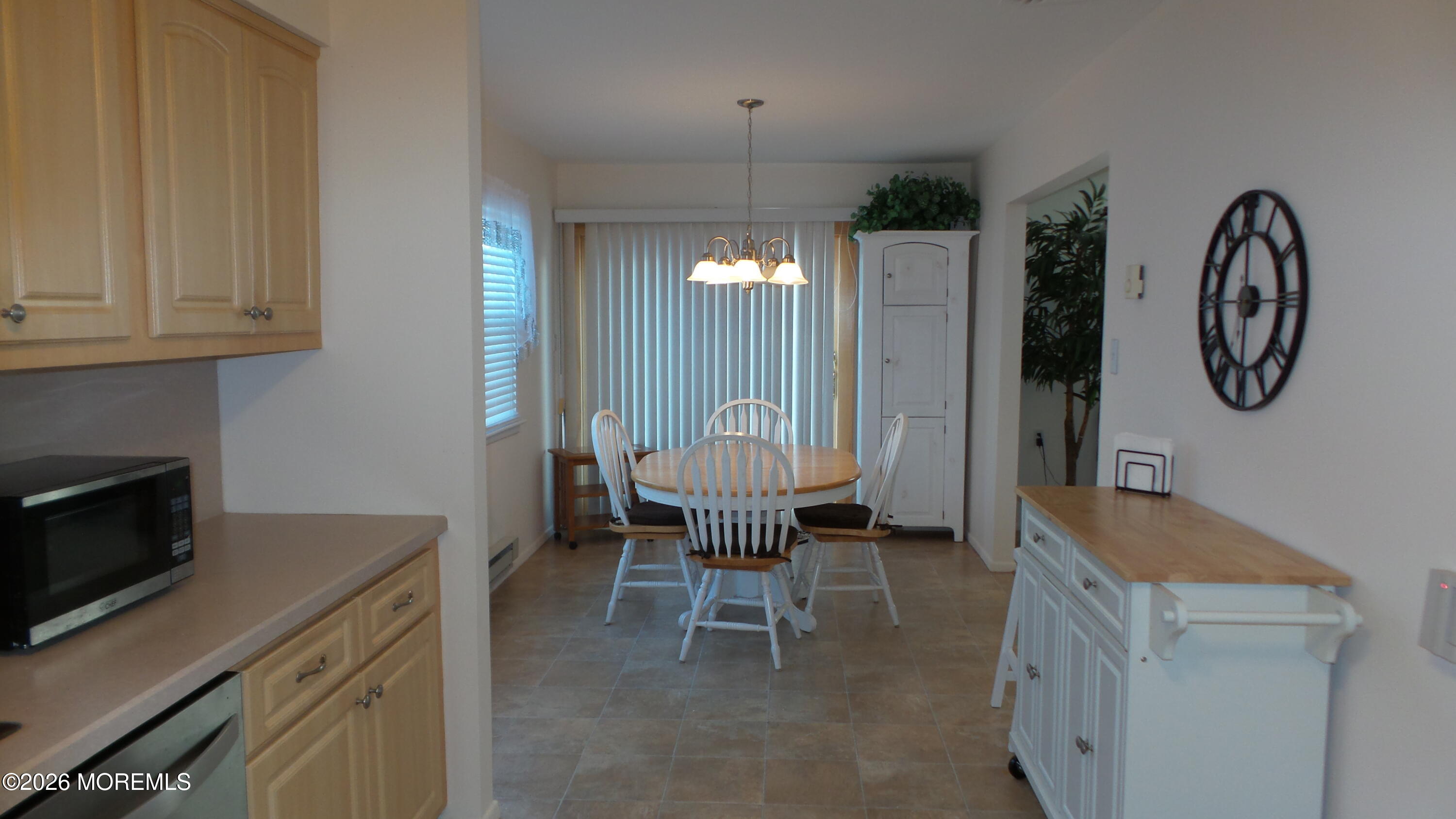 12 Barker Street Brick, NJ 08724 - Photo 7 of 17 a kitchen with a table chairs and a refrigerator