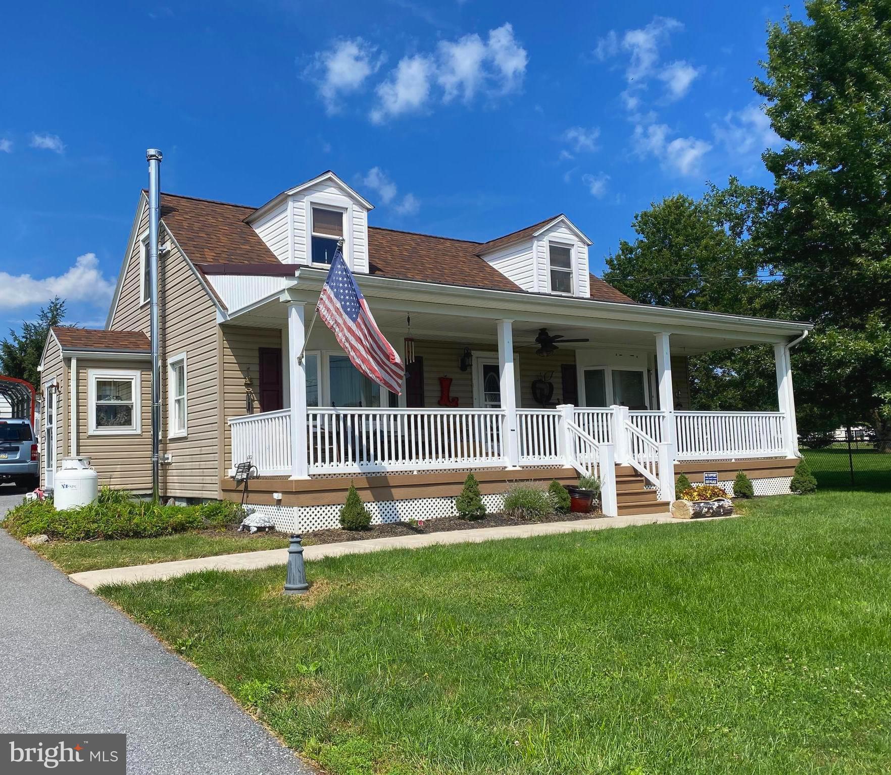 Lovely Cape Cod features a large front porch.