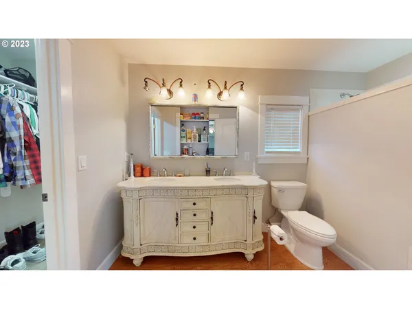 a bathroom with a sink toilet a mirror and shower