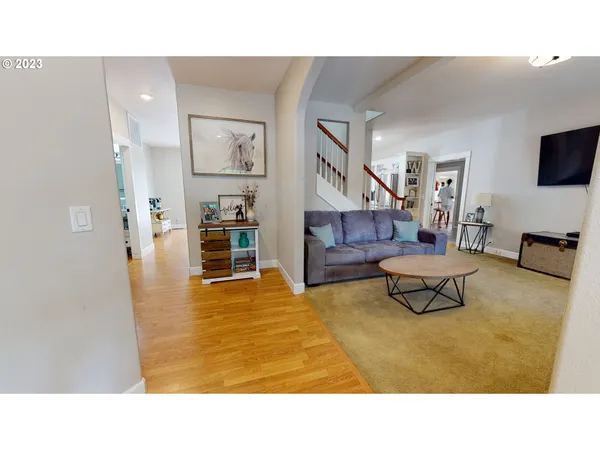 a room with furniture and a kitchen view