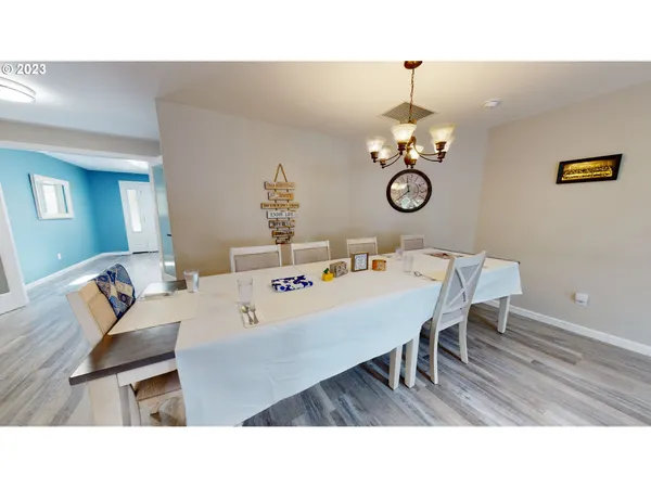 a living room with lots of furniture and view of kitchen