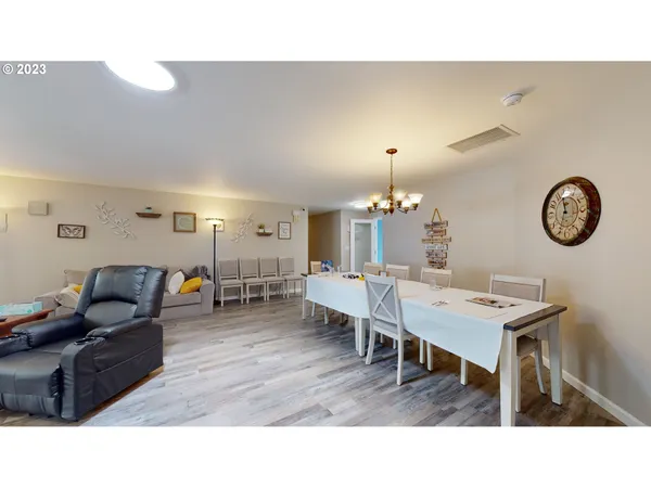 a kitchen with white cabinets and refrigerator
