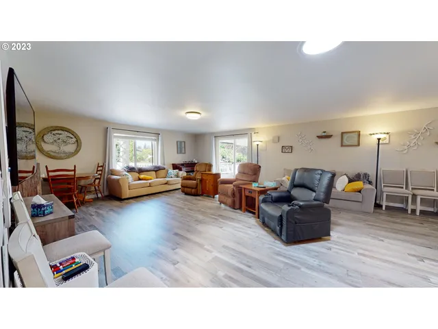 a living room with stainless steel appliances kitchen island granite countertop furniture a refrigerator and a view of living room