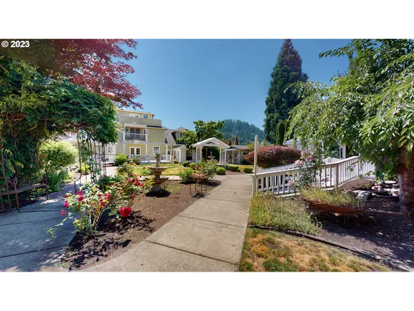 a backyard of a house with table and chairs