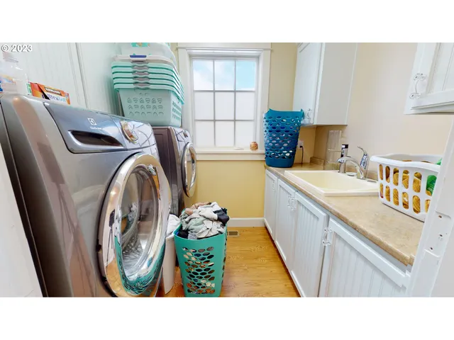 a bathroom with a sink a washer and dryer