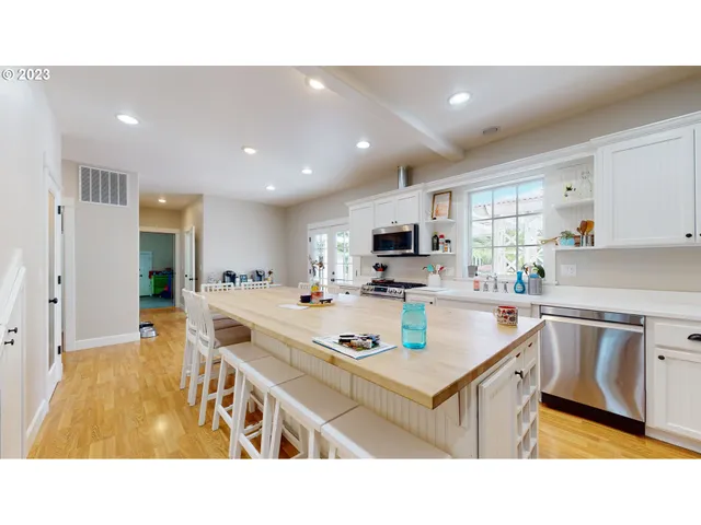a kitchen with kitchen island appliances cabinets a sink and a counter top space
