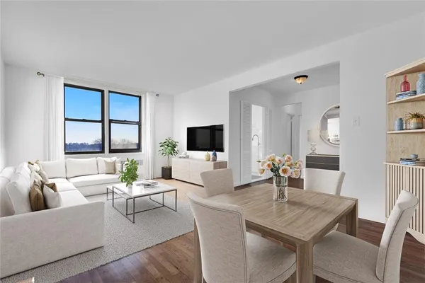 a living room with furniture wooden floor and a flat screen tv
