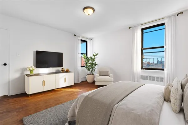 a bedroom with a bed and a flat screen tv