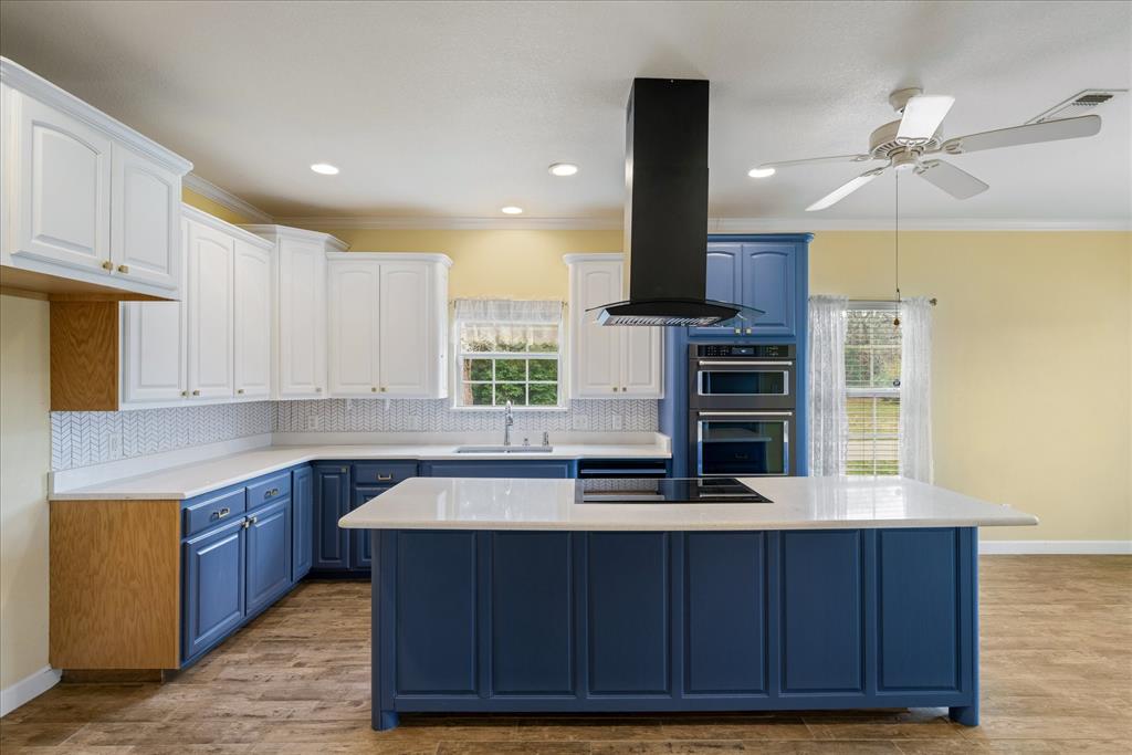 6790 County Road 1504 Athens, TX 75751 - Photo 1 of 1 a kitchen with kitchen island granite countertop a sink cabinets and stainless steel appliances