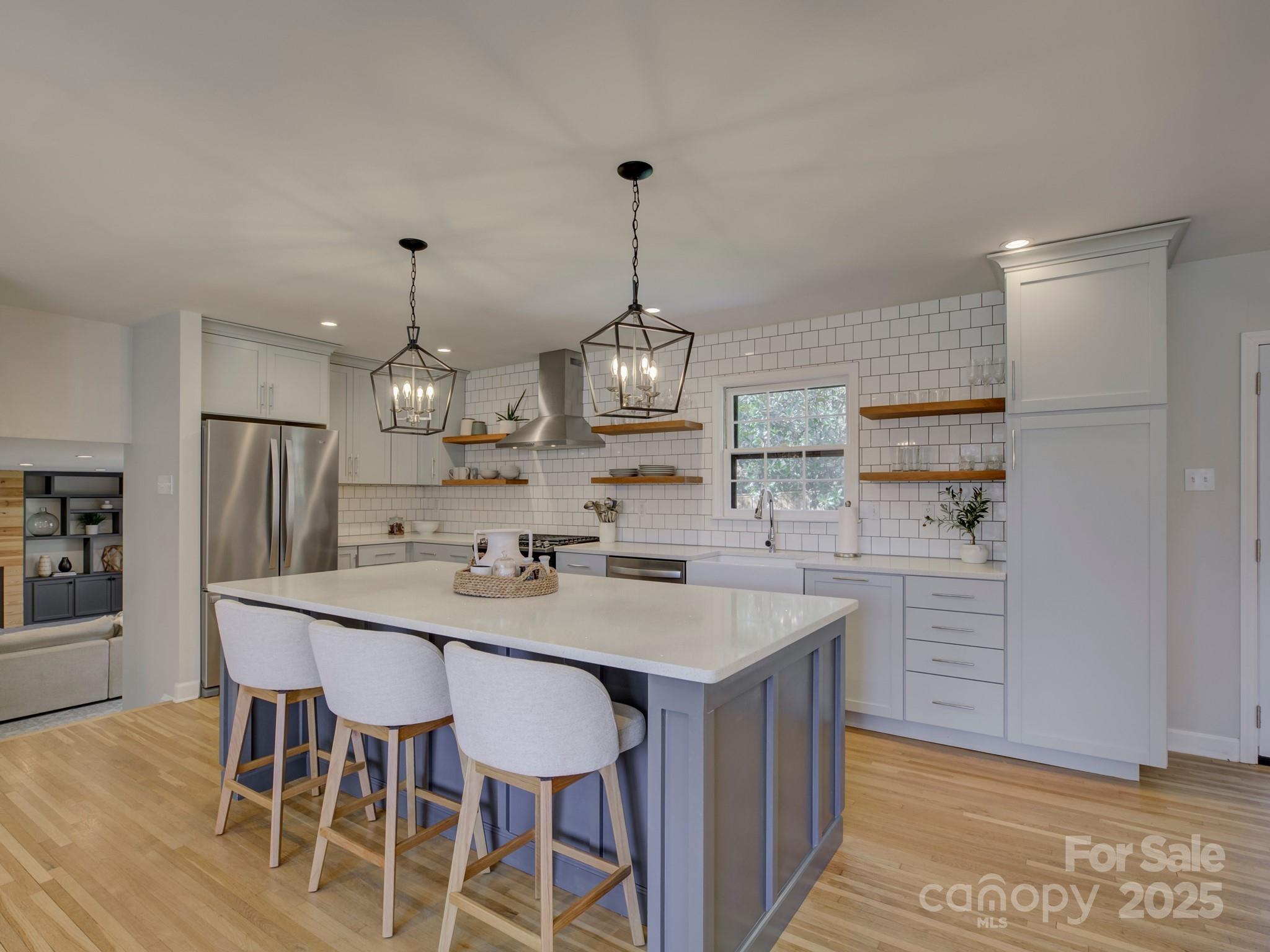 1225 Braeburn Road Charlotte, NC 28211 - Photo 16 of 45 a view of dining table chairs wooden floor and kitchen view