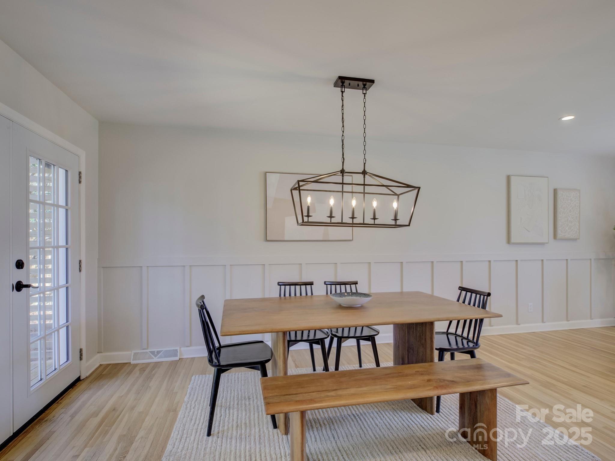 1225 Braeburn Road Charlotte, NC 28211 - Photo 20 of 45 a view of a dining room with furniture wooden floor and chandelier