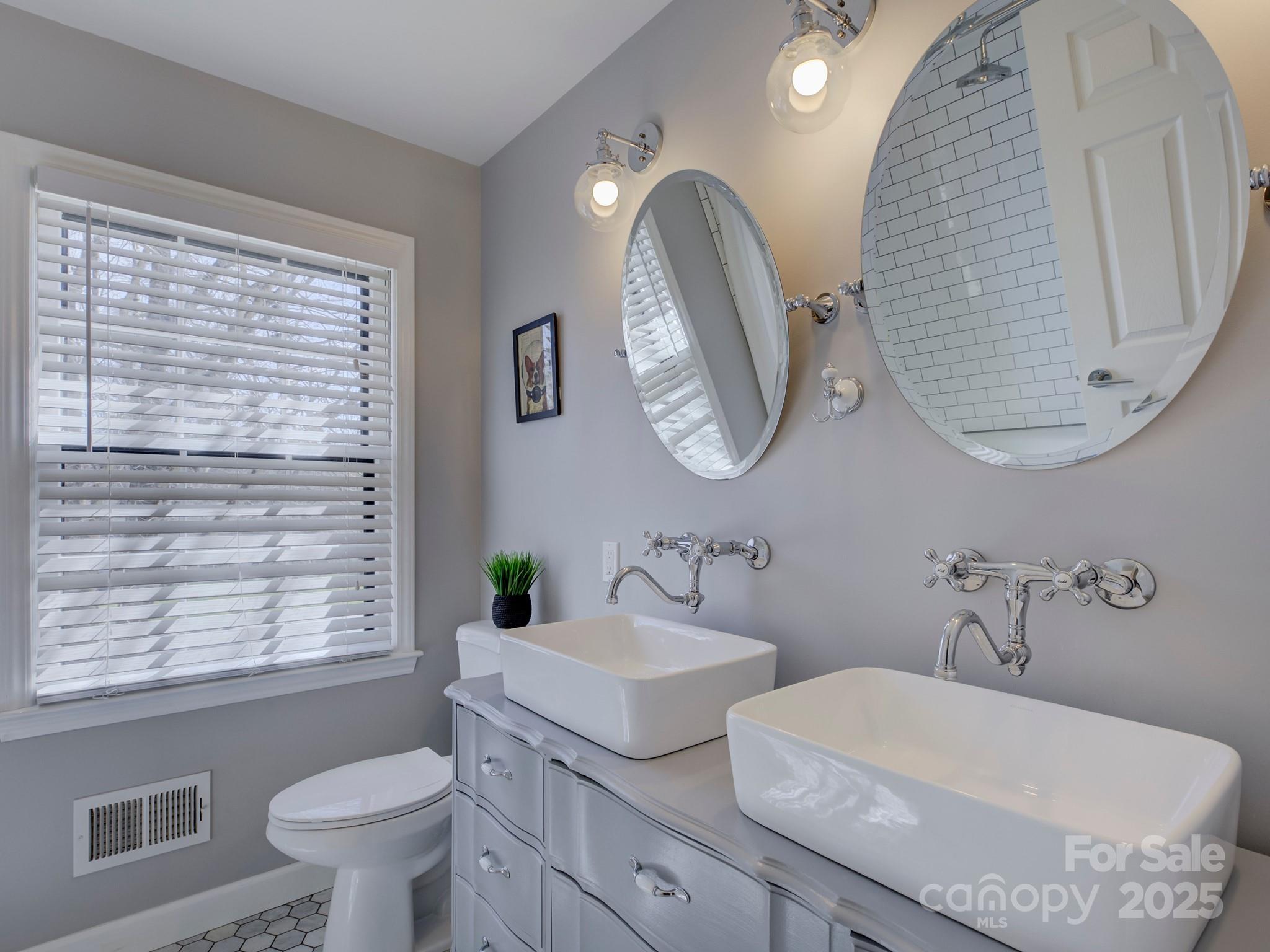 1225 Braeburn Road Charlotte, NC 28211 - Photo 26 of 45 a bathroom with a double vanity sink and a mirror