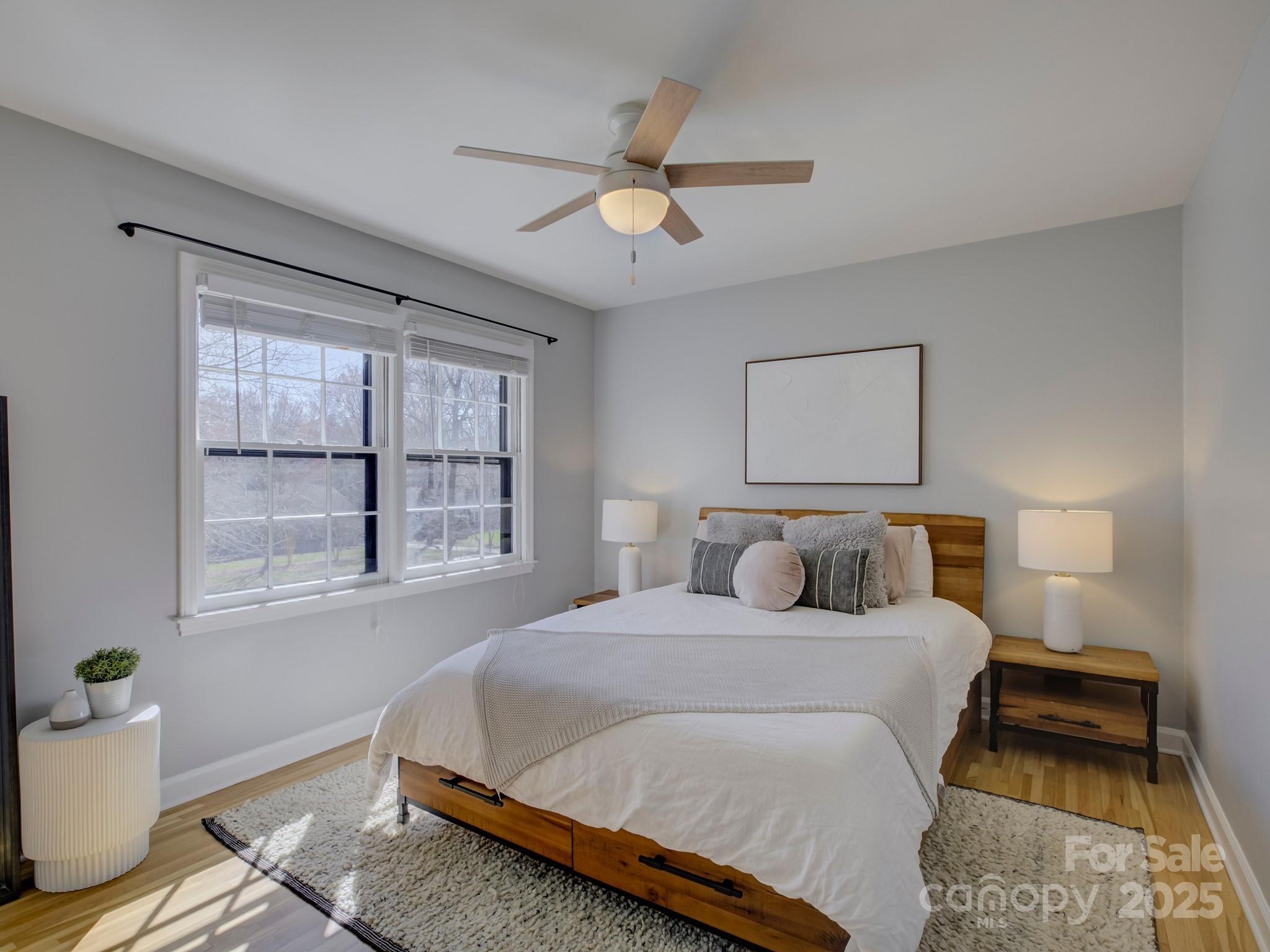 1225 Braeburn Road Charlotte, NC 28211 - Photo 28 of 45 a bedroom with a bed and wooden floor