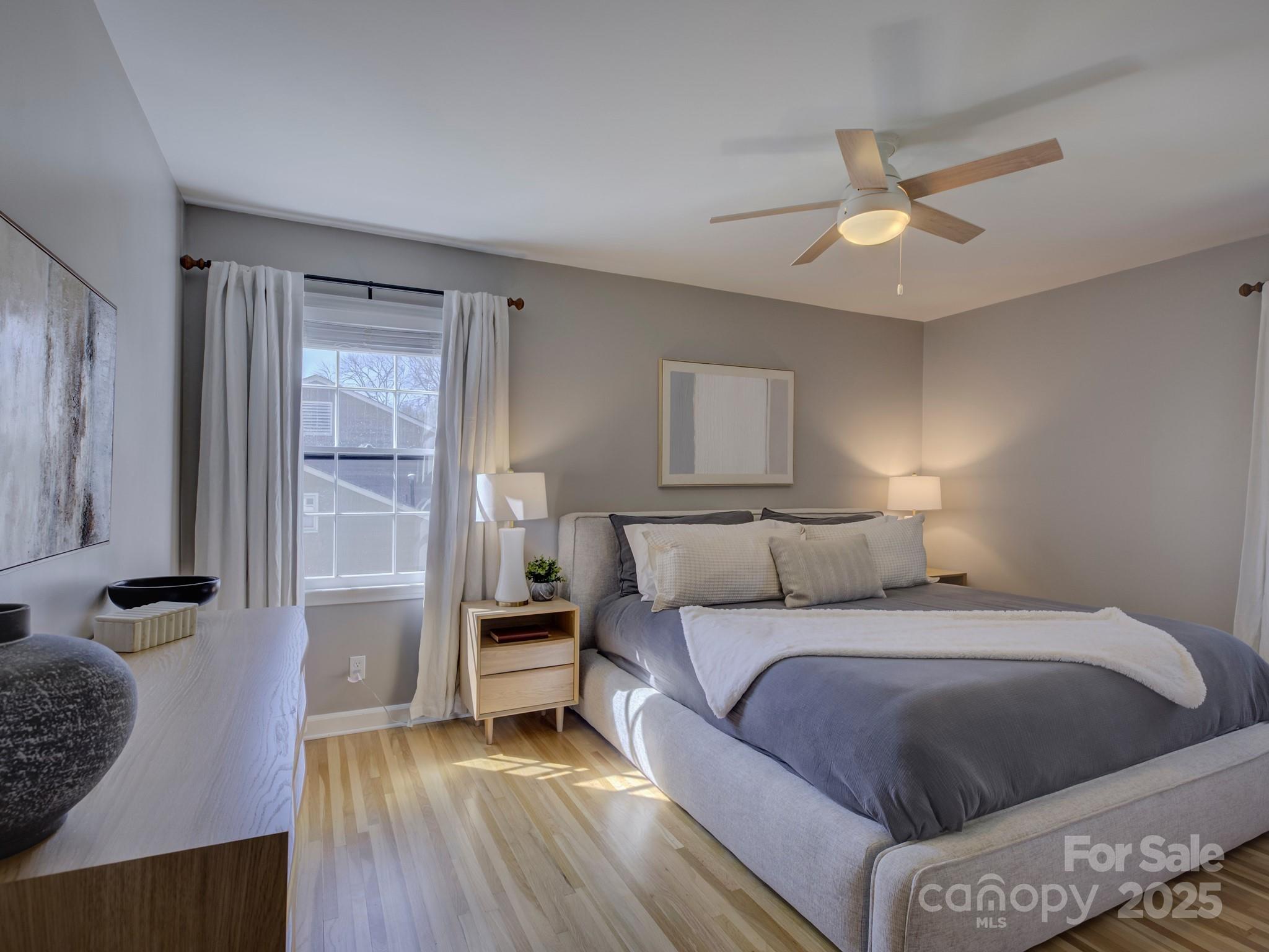 1225 Braeburn Road Charlotte, NC 28211 - Photo 29 of 45 a bedroom with a bed and wooden floor