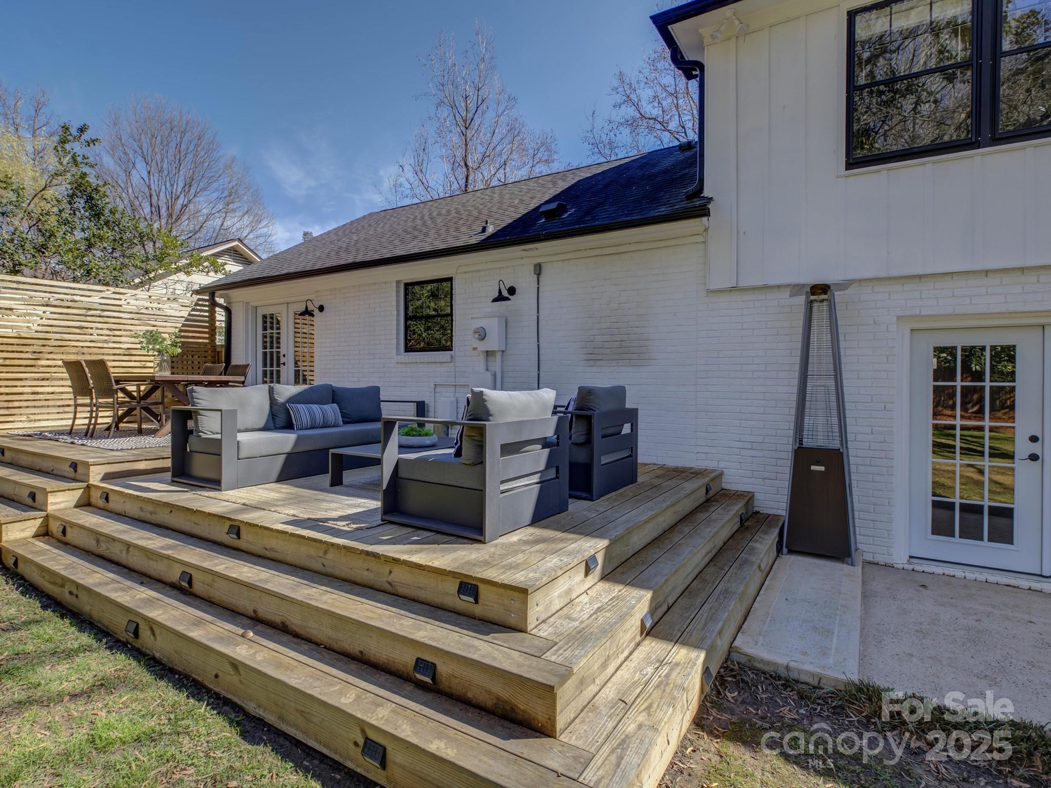 1225 Braeburn Road Charlotte, NC 28211 - Photo 40 of 45 a view of a patio with couches table and chairs and potted plants