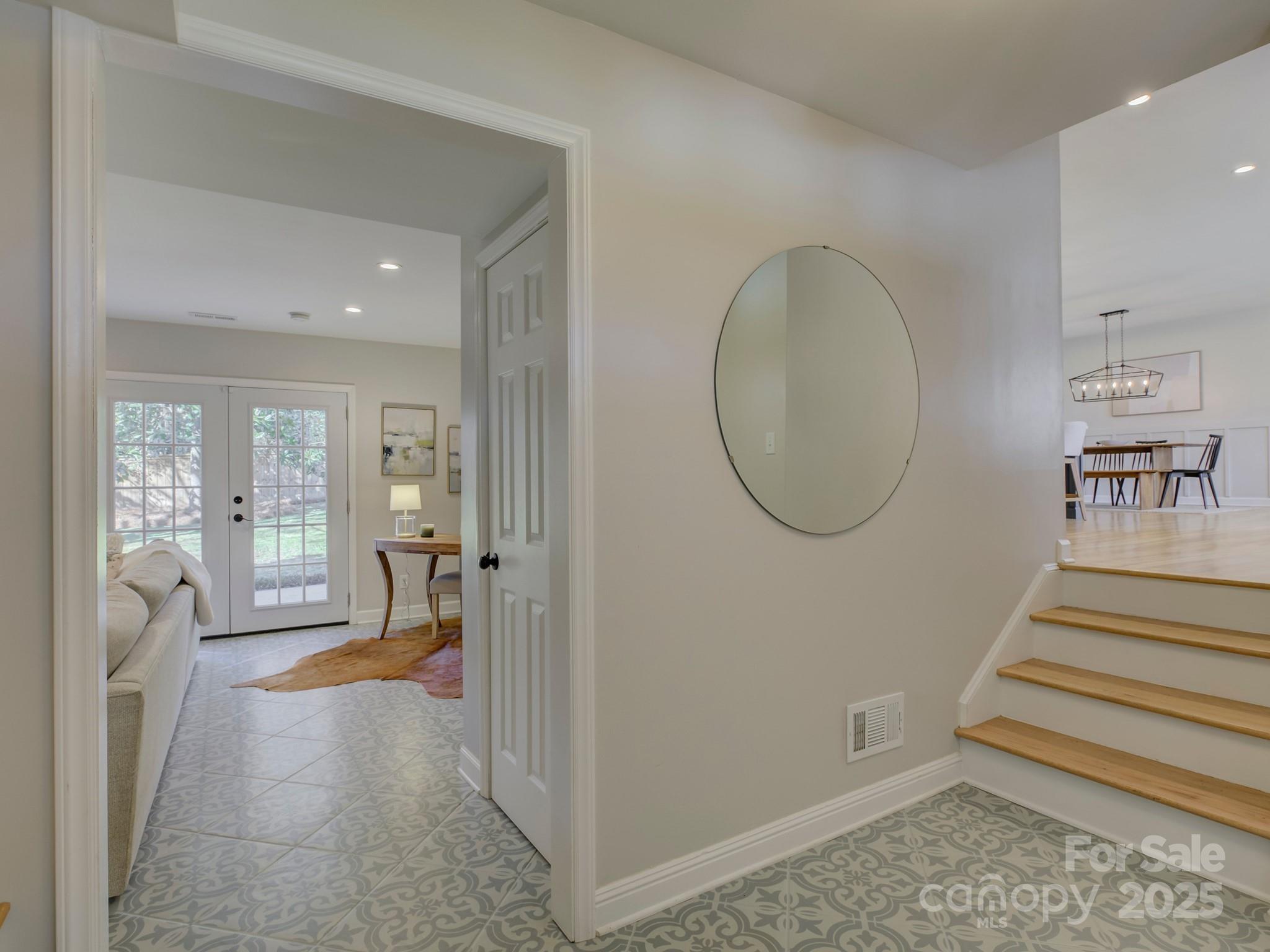 1225 Braeburn Road Charlotte, NC 28211 - Photo 5 of 45 a view of an entryway with wooden floor and a livingroom view
