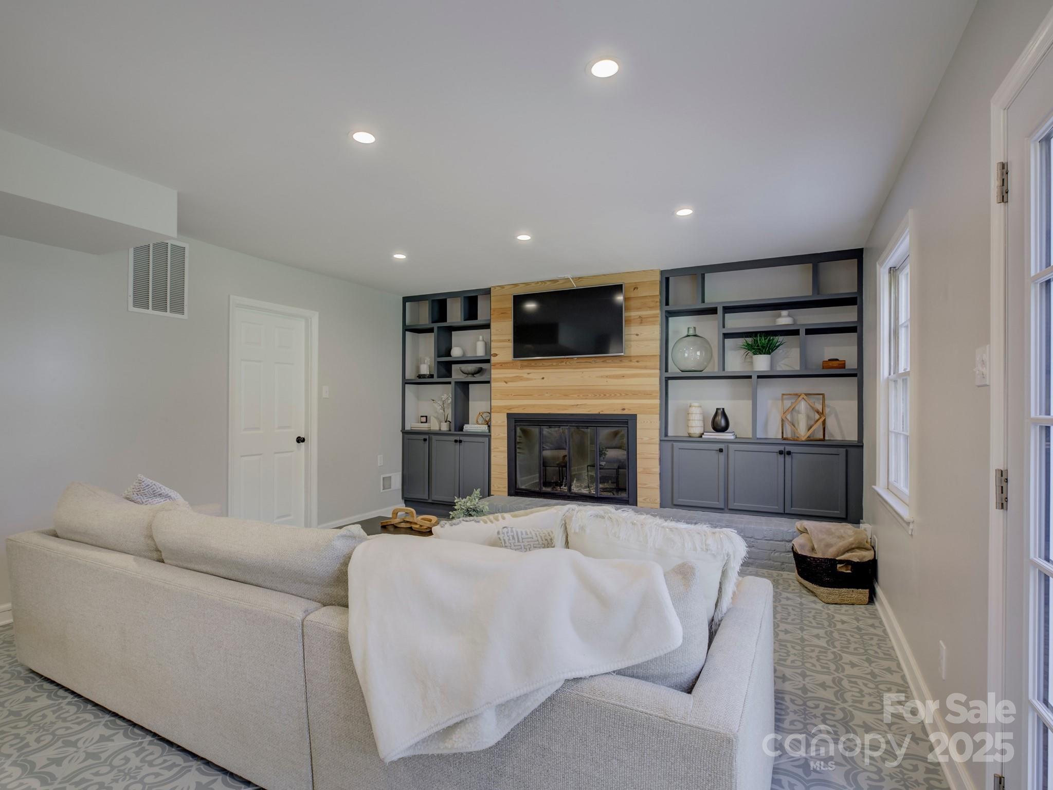 1225 Braeburn Road Charlotte, NC 28211 - Photo 10 of 45 a living room with furniture fireplace and a television