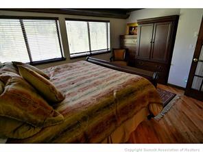 1944 Soda Ridge Road, Unit 229 Keystone, CO 80435 - Photo 15 of 25 a bedroom with a bed and wooden floor