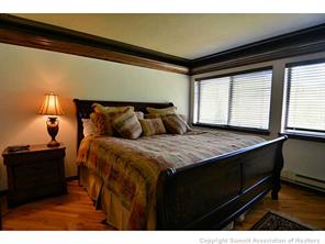 1944 Soda Ridge Road, Unit 229 Keystone, CO 80435 - Photo 19 of 25 a bedroom with a bed and wooden floor