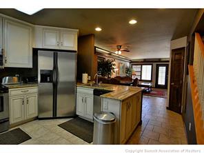 1944 Soda Ridge Road, Unit 229 Keystone, CO 80435 - Photo 20 of 25 a kitchen with kitchen island a counter top space a sink stainless steel appliances and cabinets