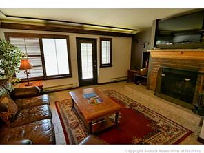 1944 Soda Ridge Road, Unit 229 Keystone, CO 80435 - Photo 3 of 25 a living room with furniture and a fireplace