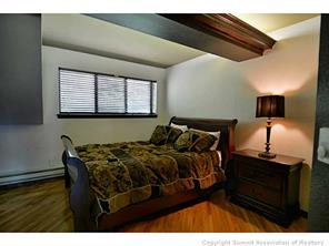 1944 Soda Ridge Road, Unit 229 Keystone, CO 80435 - Photo 7 of 25 a bedroom with a bed and a night stand