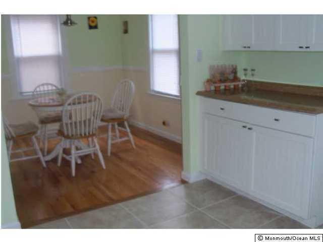 15 Via Ripa Sea Bright, NJ 07760 - Photo 3 of 3 a kitchen with stainless steel appliances granite countertop a sink a microwave cabinets and a dining table