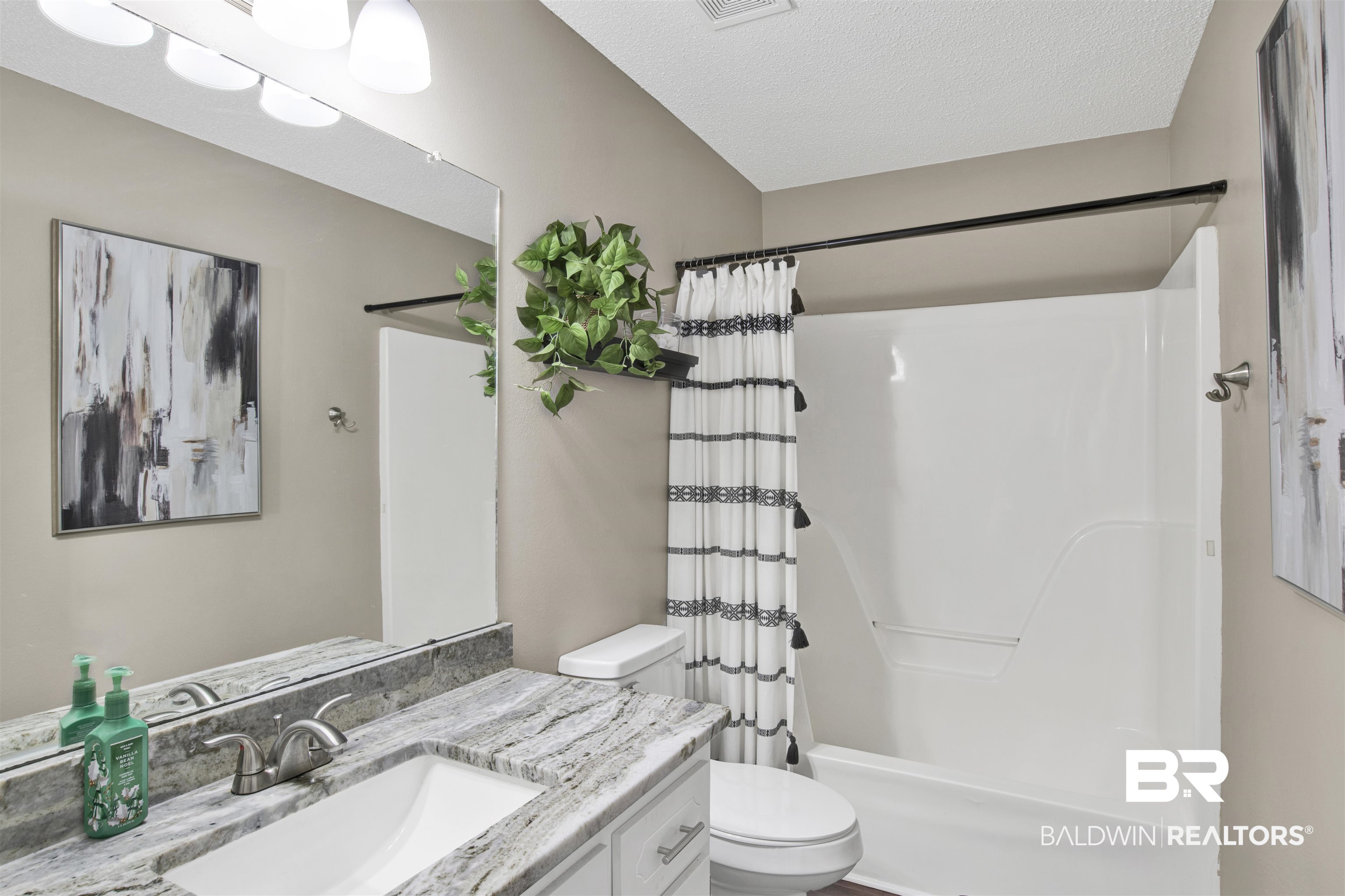 6281 Woodside Drive Theodore, AL 36582 - Photo 12 of 17 Full bathroom with vanity, a textured ceiling, and shower / bath combination with curtain