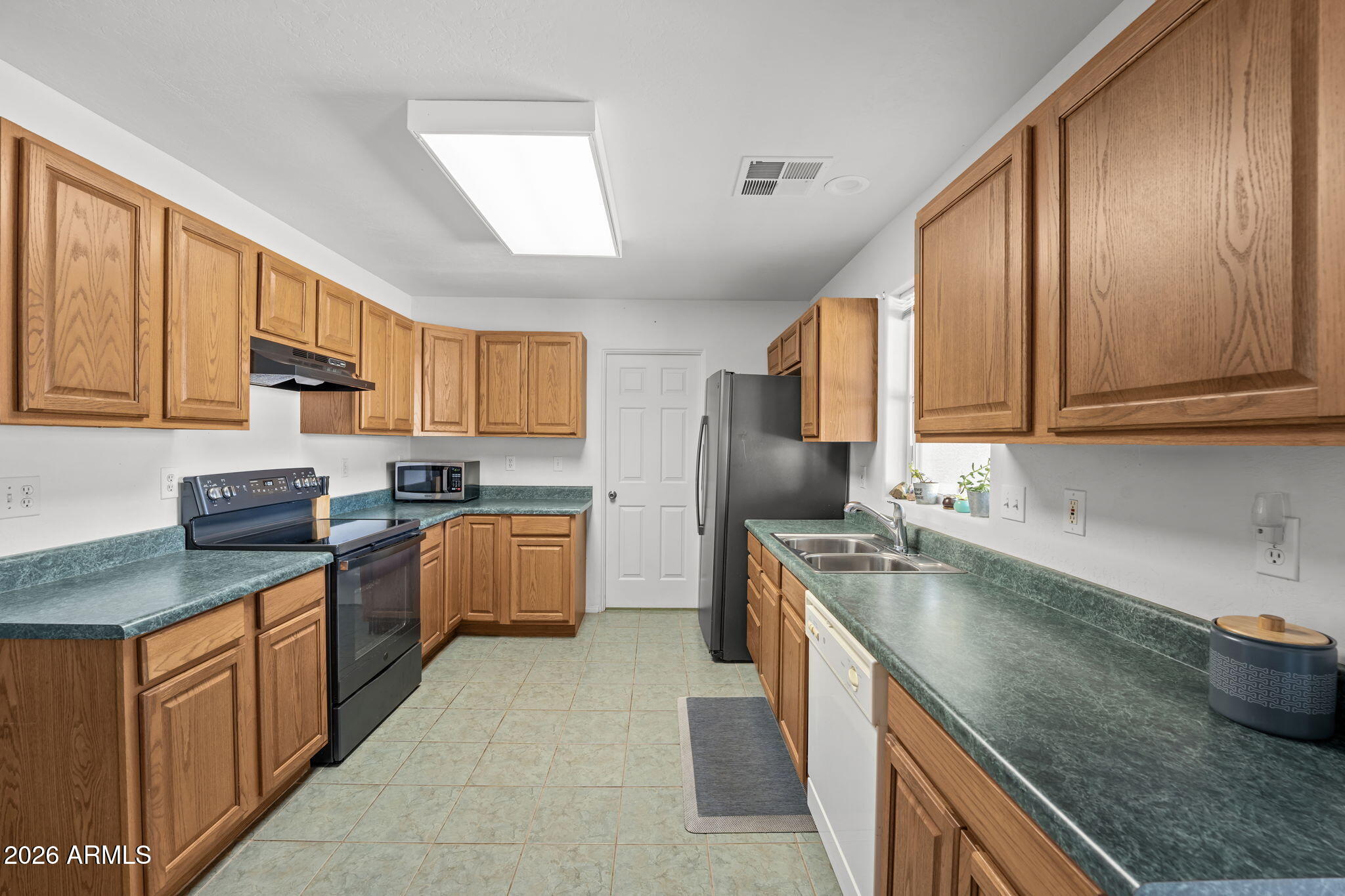 27144 Bennett Way Congress, AZ 85332 - Photo 17 of 33 a kitchen with stainless steel appliances granite countertop a sink stove and refrigerator