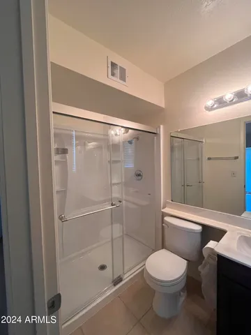 a bathroom with a toilet and a shower