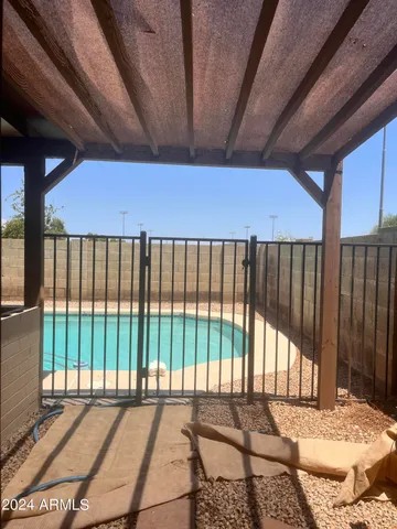 a backyard of a house with table and chairs