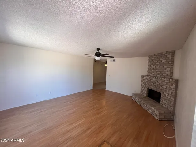 wooden floor in an empty room with a fireplace
