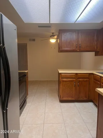 a view of a refrigerator and cabinets