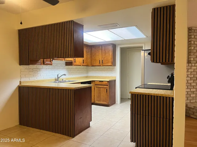 a kitchen with a sink a stove and a refrigerator